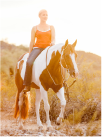 Author Carly Kade Riding her Paint Horse